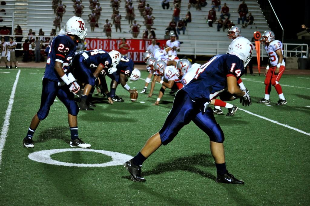 The players prepare for the ball to be hiked in the hopes of getting a first down. Photo by Jamie Gallegos