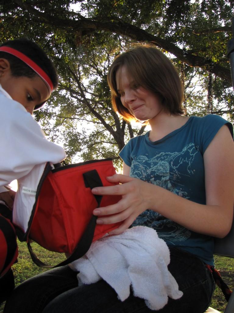 Scarlet Snodgrass lets children pick their "tattoos" at Trisun Healthcare's Fall Festival. Photo By Andrea Logan