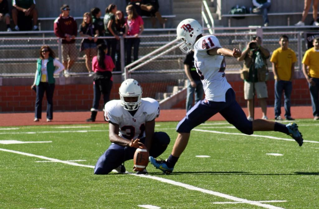 Leland Young, senior, holds the snap for kicker, Deric Eldridge, senior, to kick a field goal.