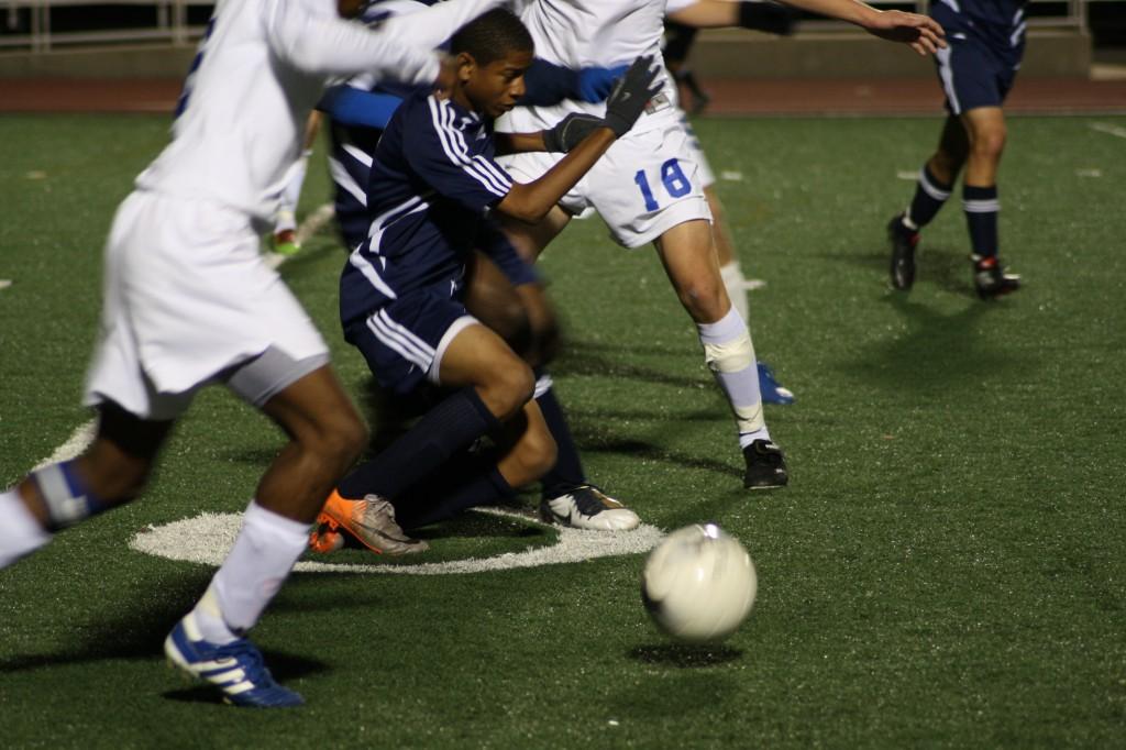 The Roosevelt player fights his way to the ball to move it down the field. Photo by Andrea Logan