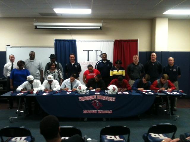 The seniors sign commitments to their college teams. 