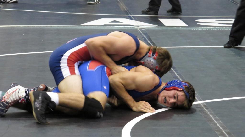 Varsity wrestling to open district today
