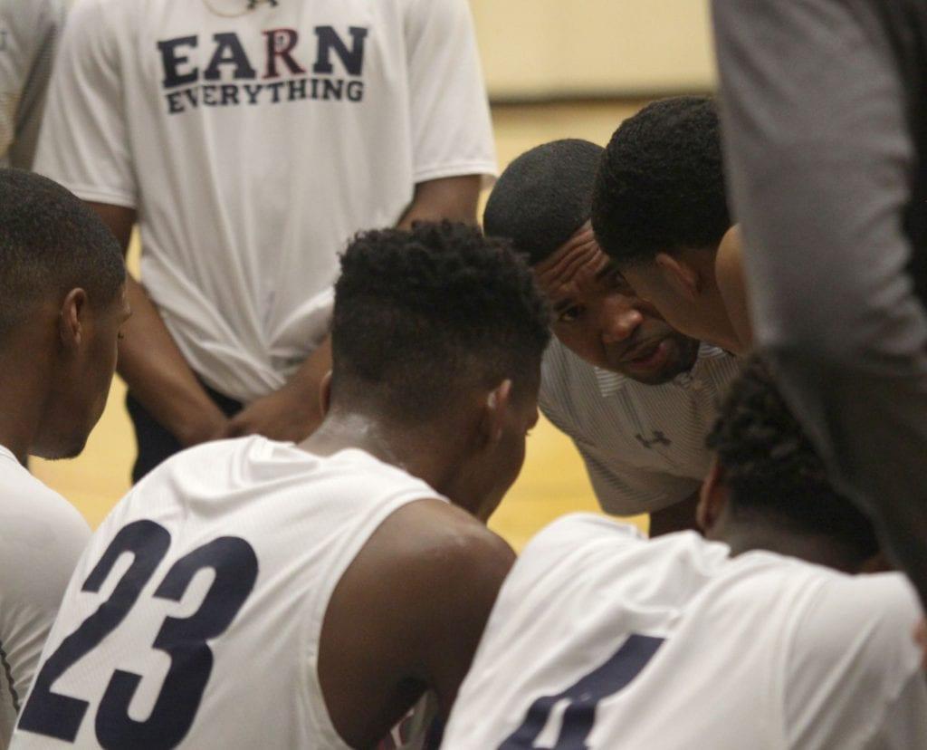 The Riders talk things over at a recent game. Their team shirts remind them to "Earn Everything." Photo by Austin Cohea