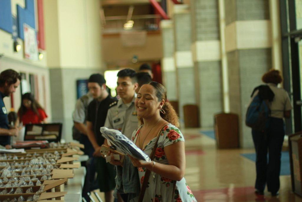 Senior Audrianna Leal picks up her cap and gown from Josten's. She and other seniors are busy making choices about their next steps. Photo by Austin Cohea