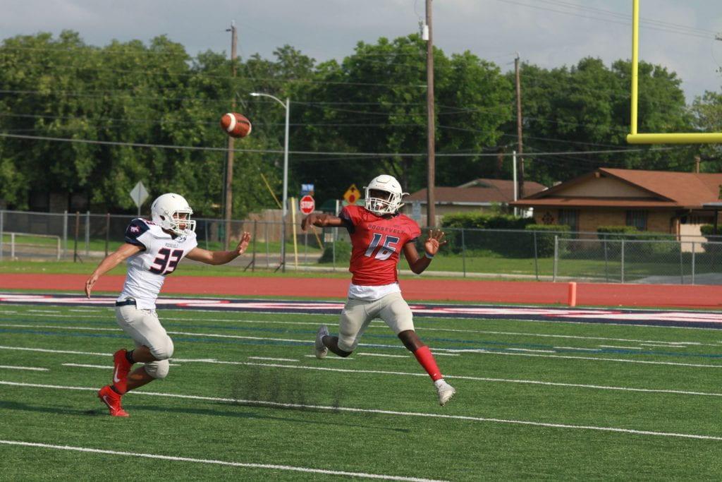 Sophomore Damon Christinia defends sophomore Dewayne Coleman as he prepares to receive the pass at the spring game. Photo by Austin Cohea