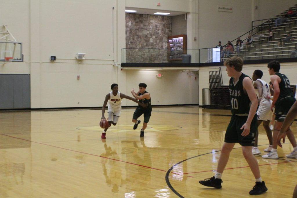 Senior Daqwon Kindred rushes the ball past a Reagan defender in an earlier district game.  Kindred helped lead the effort against Johnson last week with points. Photo by Destiny Carter. 